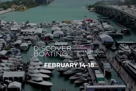 Discover Boating logo and Miami International Boat Show event details over a busy marina filled with various boats, February 14-18.